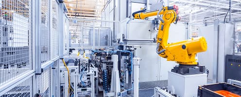 Automated discrete manufacturing facility with robotic production equipment