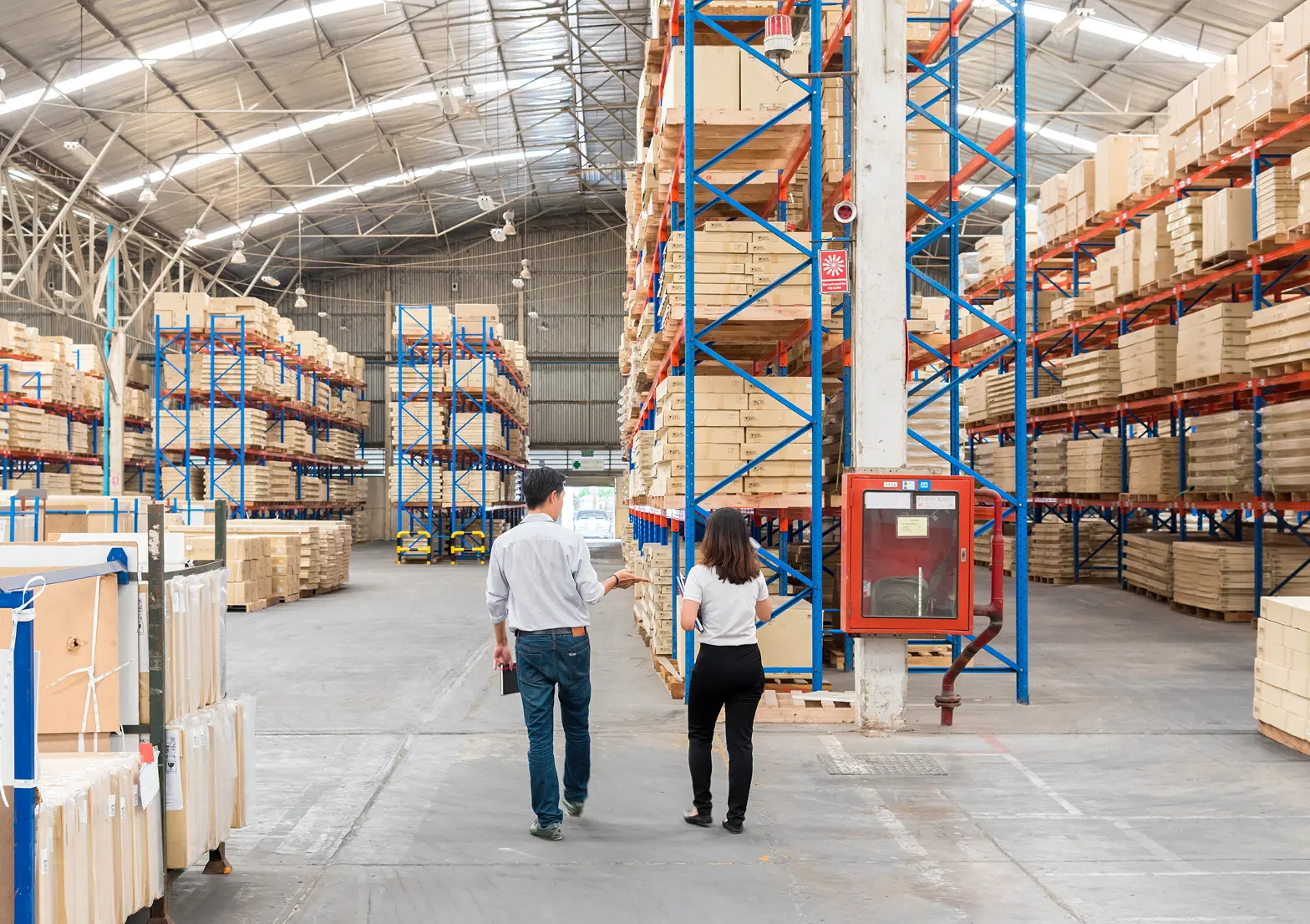 Warehouse officer checking inventory on storage shelves