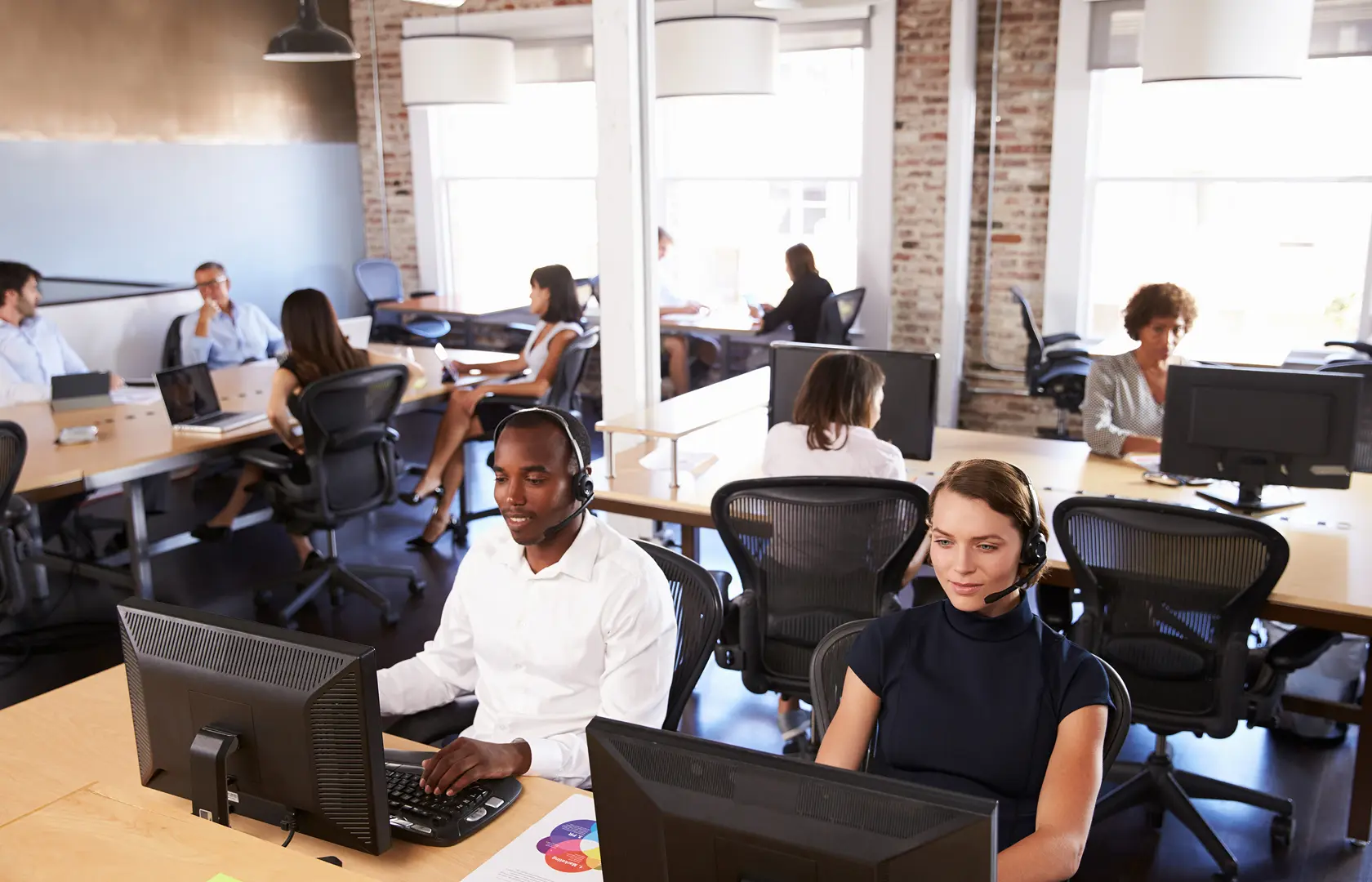 Customer service staff working in a busy support department