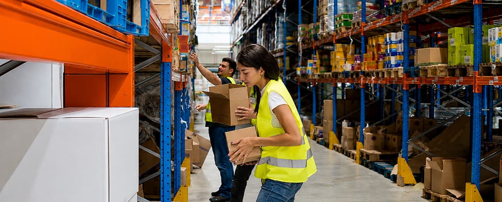 Workers handling goods inside a warehouse storage facility
