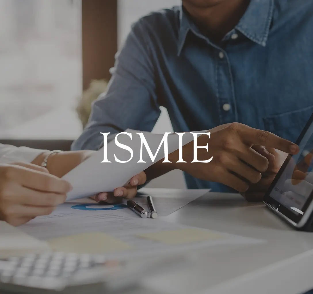 ISMIE Mutual Insurance Company logo with a background featuring two businesspeople sitting with a tablet and some papers.