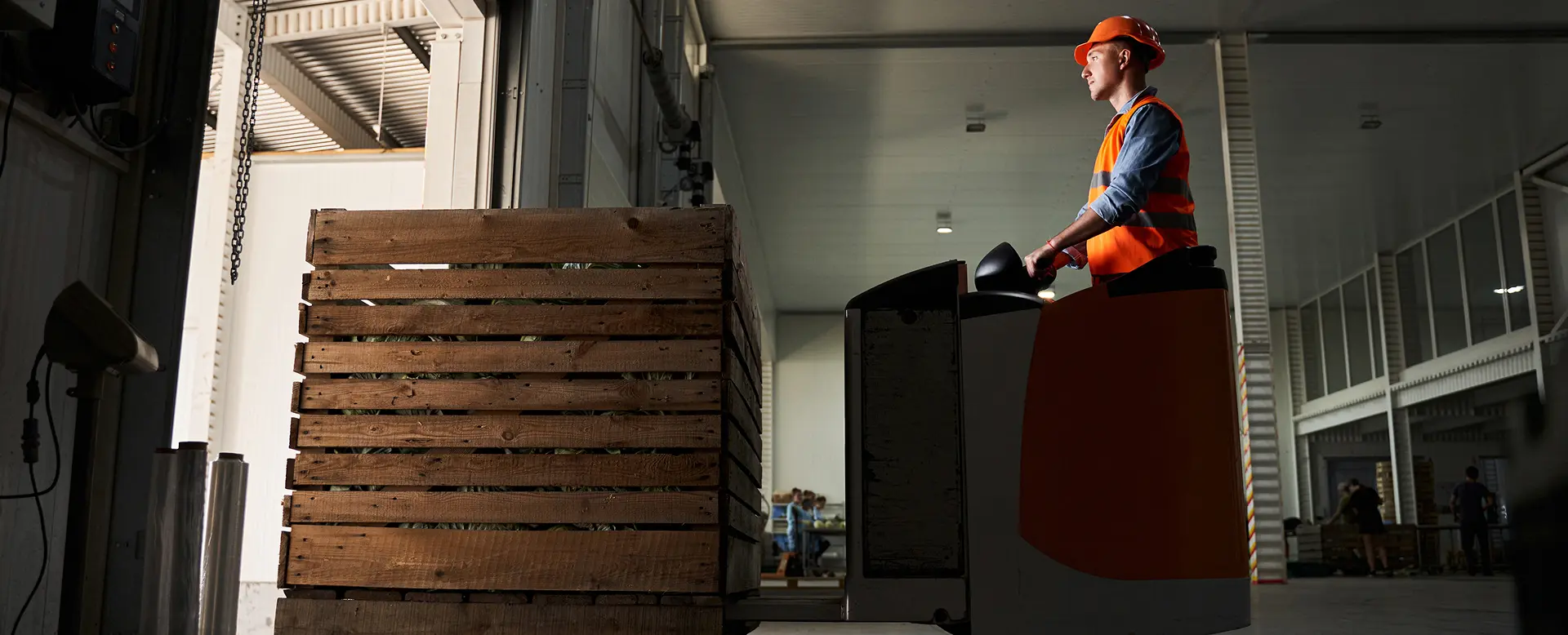 Forklift operator transporting stock through a warehouse