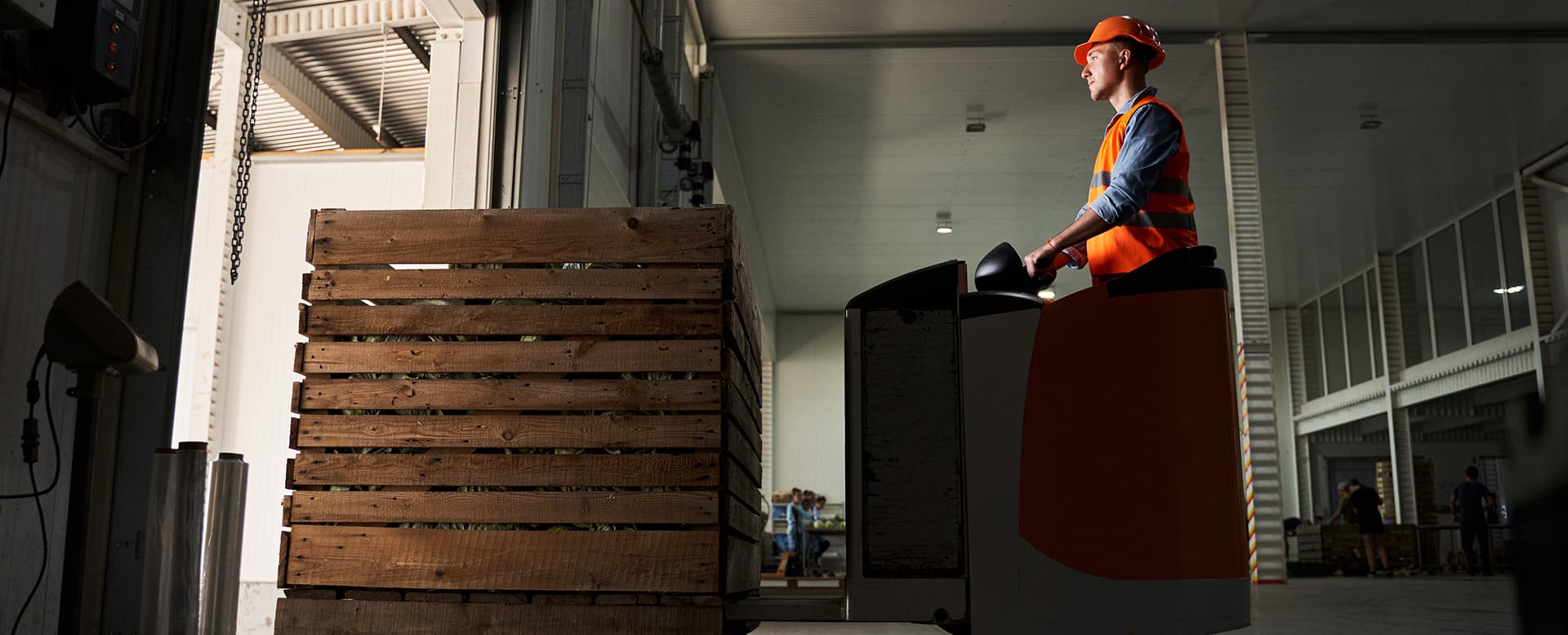 Forklift operator transporting stock through a warehouse