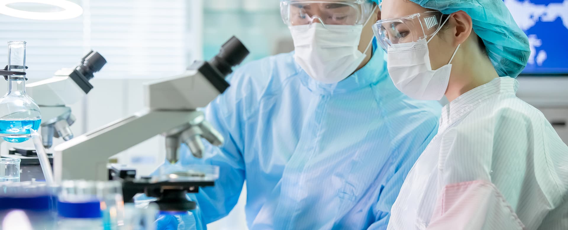 Young scientist using a microscope in a laboratory