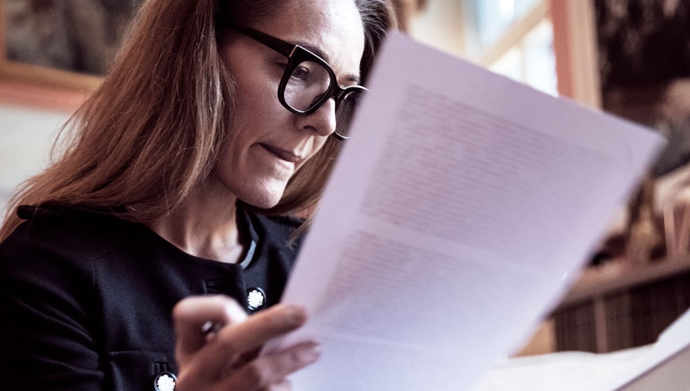 card-woman-reading-financial-document