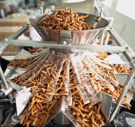 Closeup of salty snacks in food factory production line.