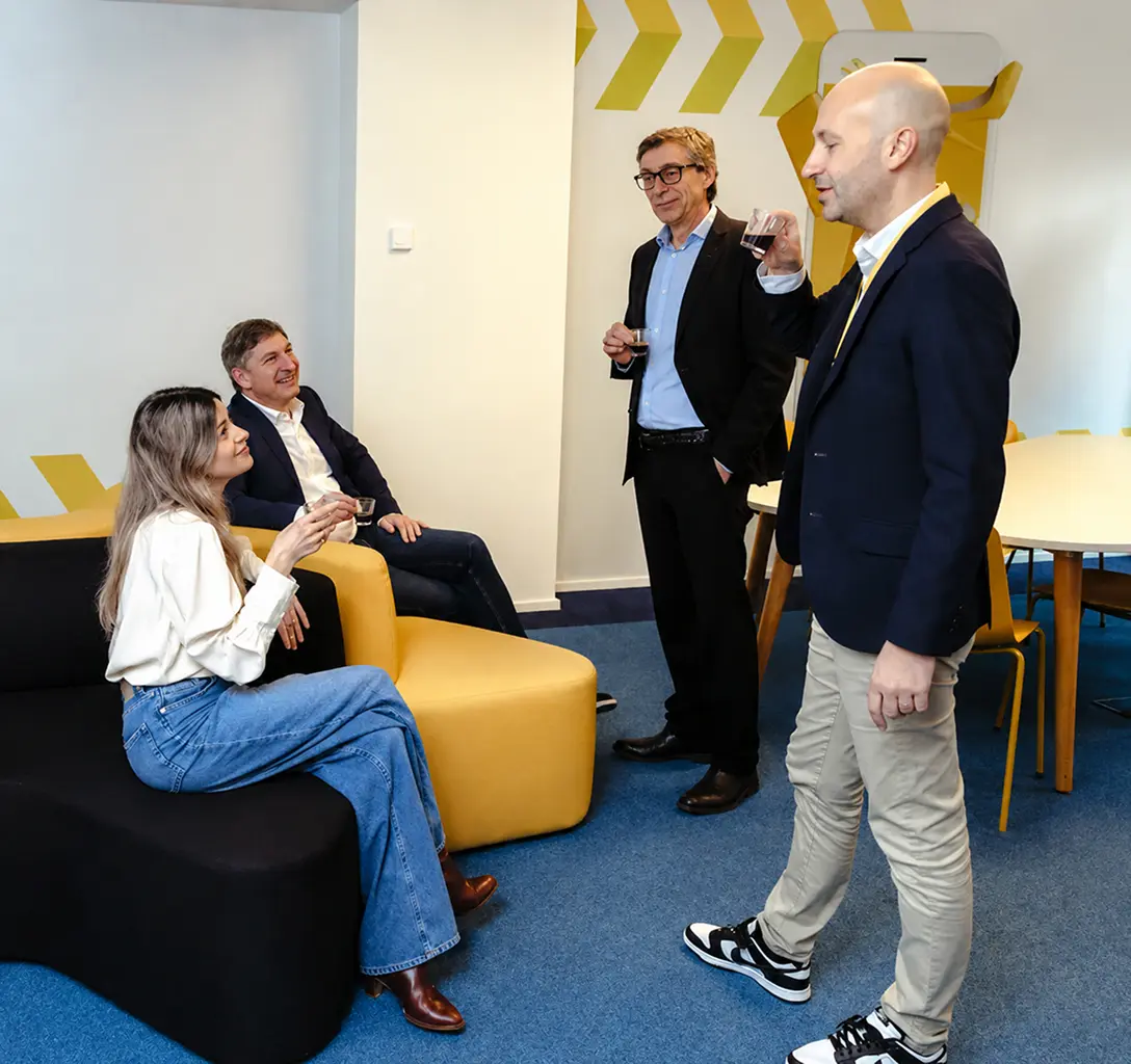 Aptean team members collaborating in a workplace lounge area