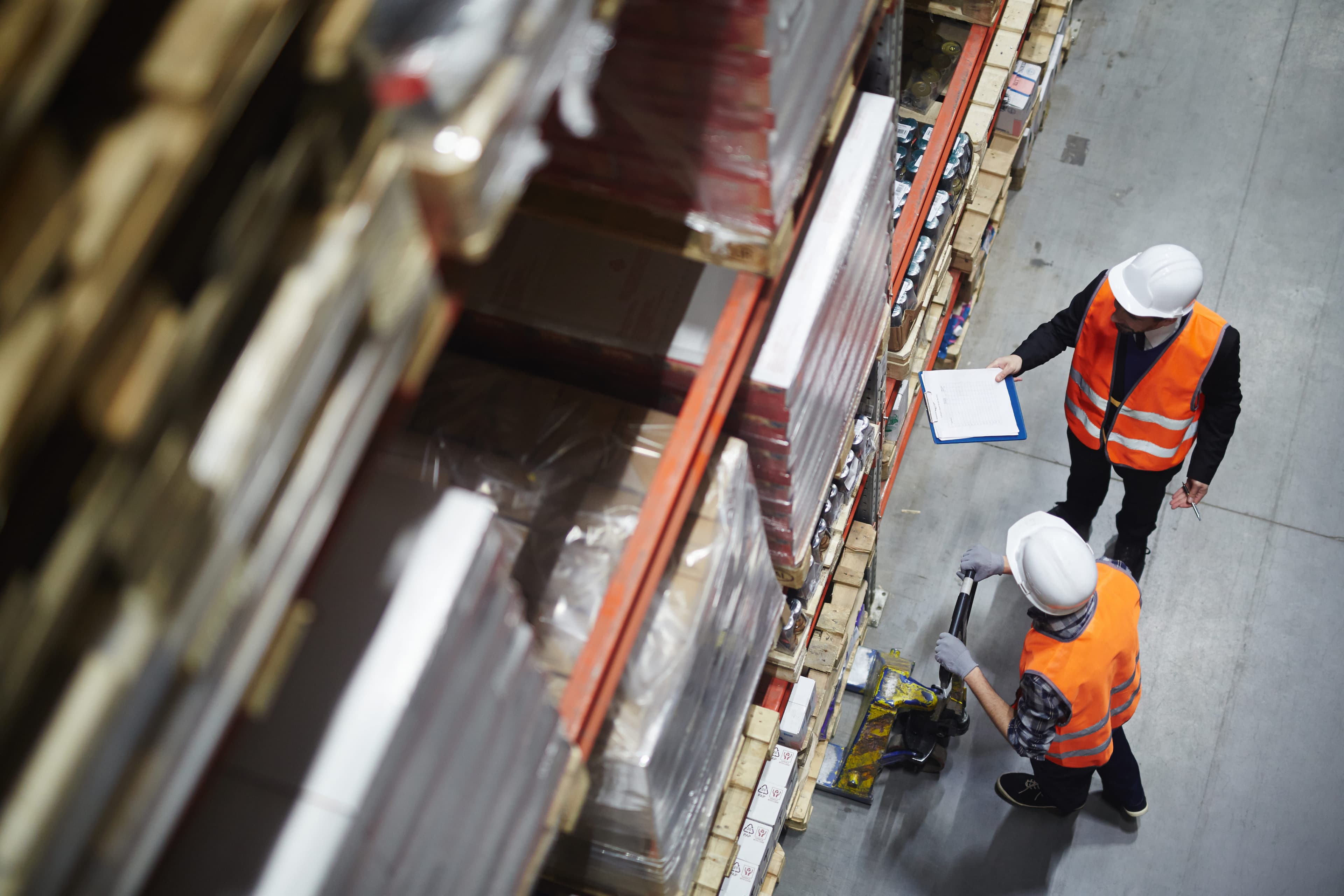 Wholesale workers making revision of goods in warehouse