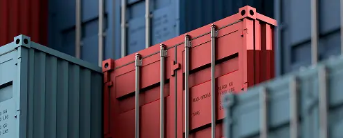 Stacked shipping containers in logistics yard close-up