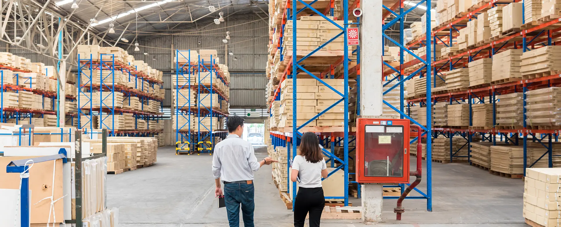 Warehouse officer checking inventory on storage shelves