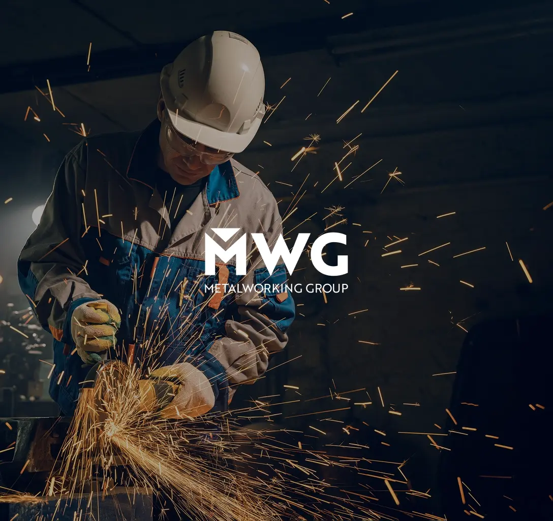 The Metalworking Group logo, featuring a man cutting metal in the background.