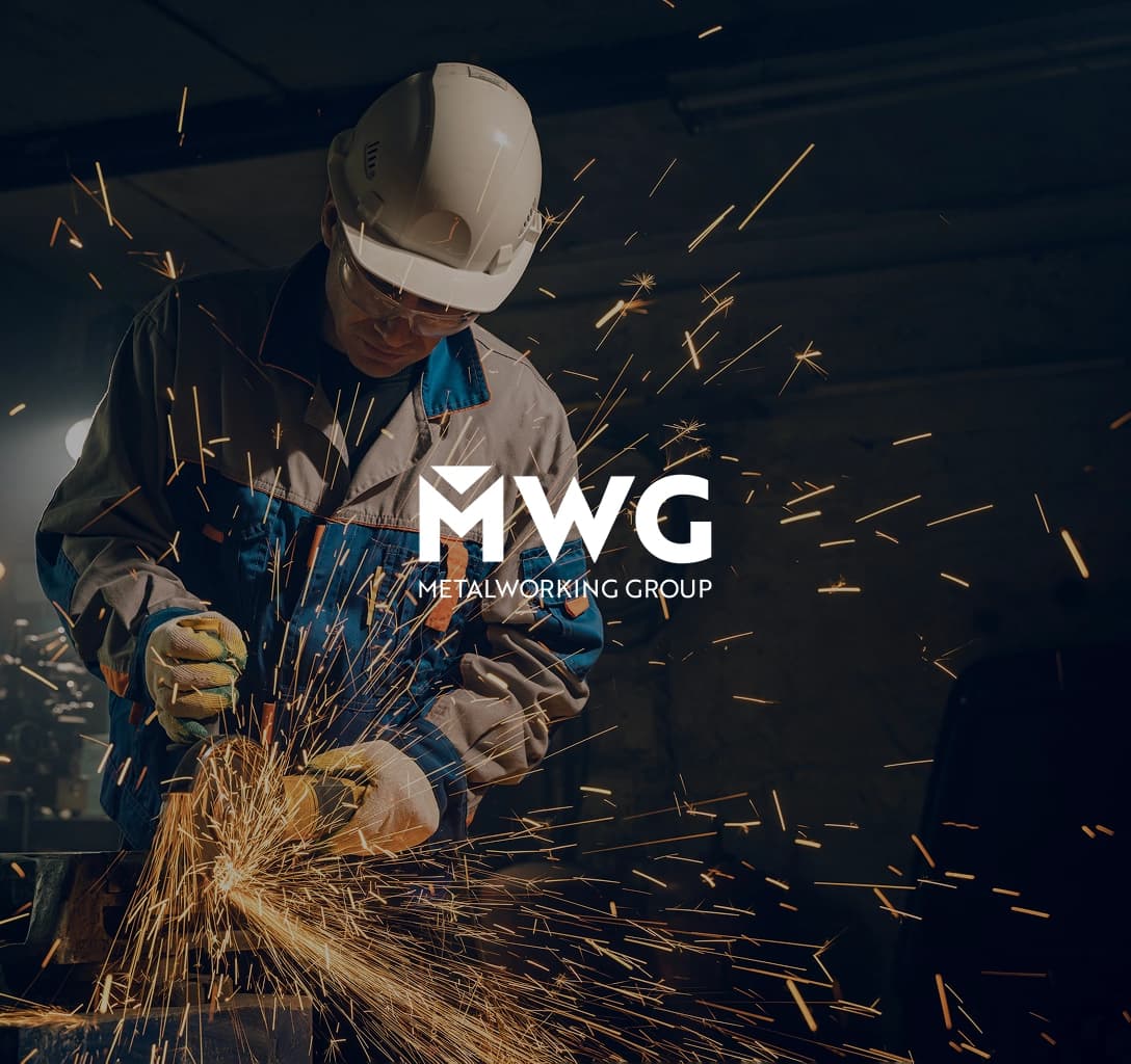 The Metalworking Group logo, featuring a man cutting metal in the background.