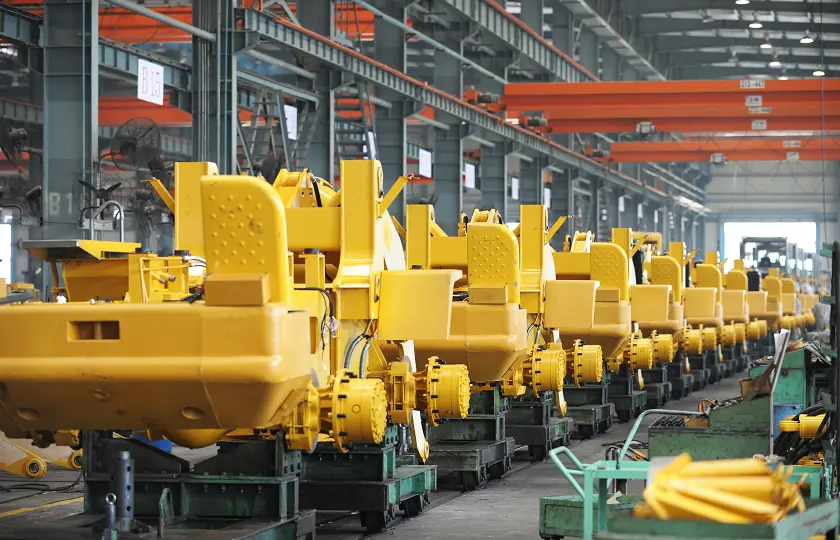 Excavator parts being manufactured inside a machine shop