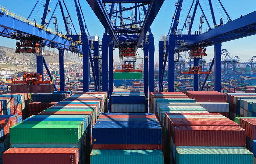 Aerial view of colourful shipping containers at a seaside logistics port