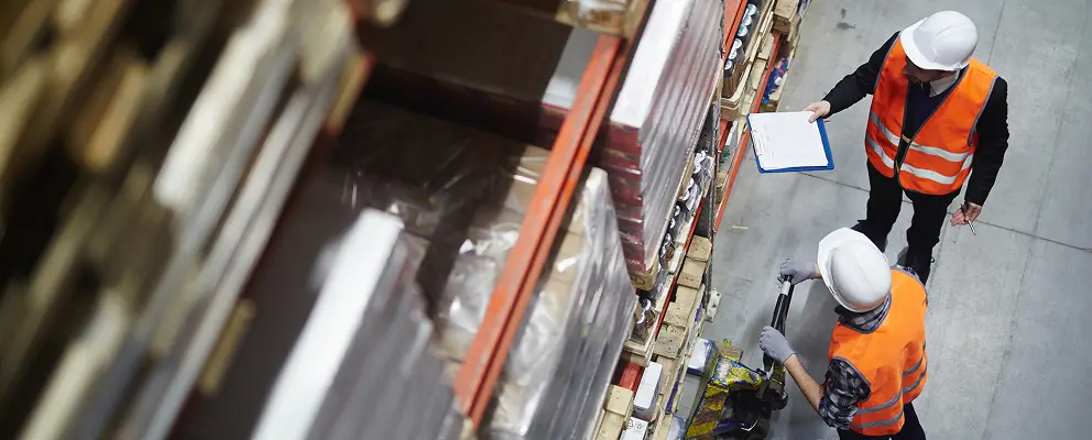 Wholesale workers making revision of goods in warehouse