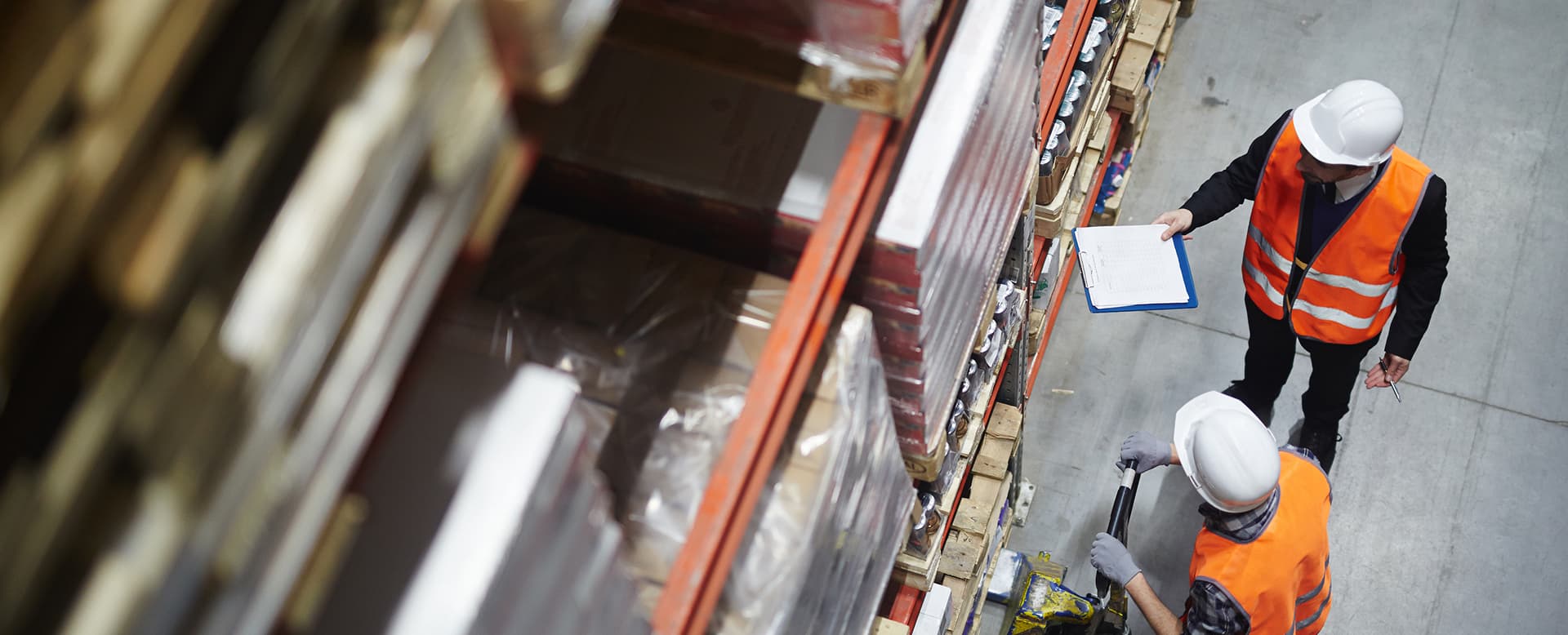Wholesale workers making revision of goods in warehouse